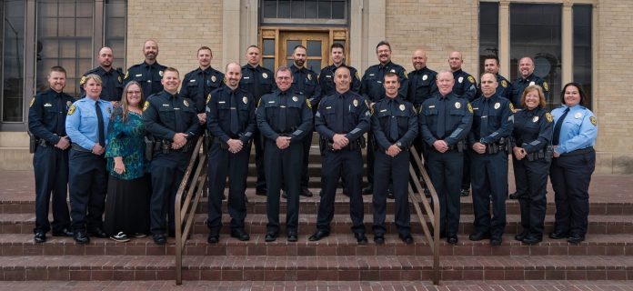 A group photo of all the security personals of a police station standing together