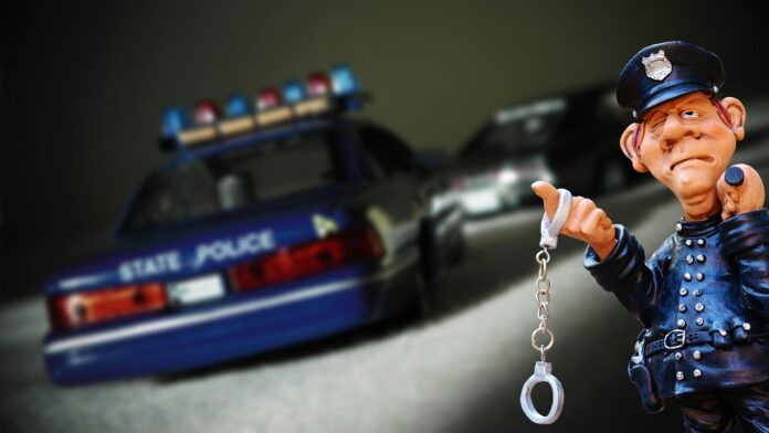 A picture of the police car and police with handcuffs