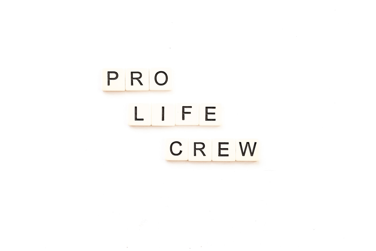 the words pro life crew spelled with scrabble letters