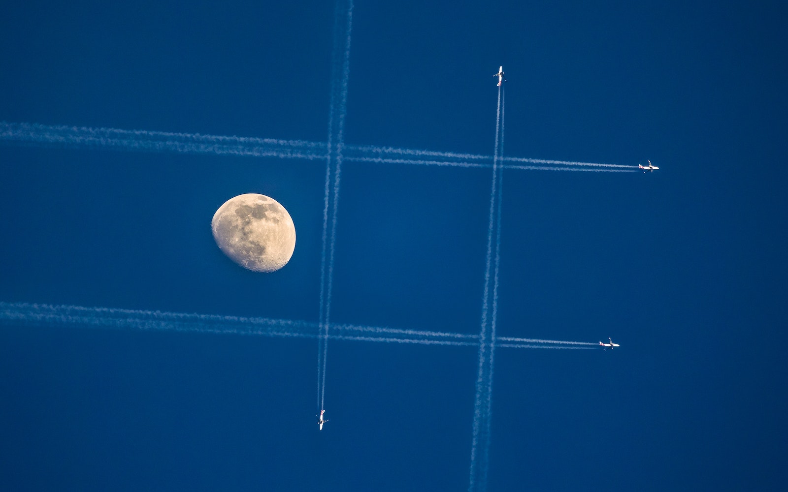 Jet Air Show on Clear Blue Sky Near Moon