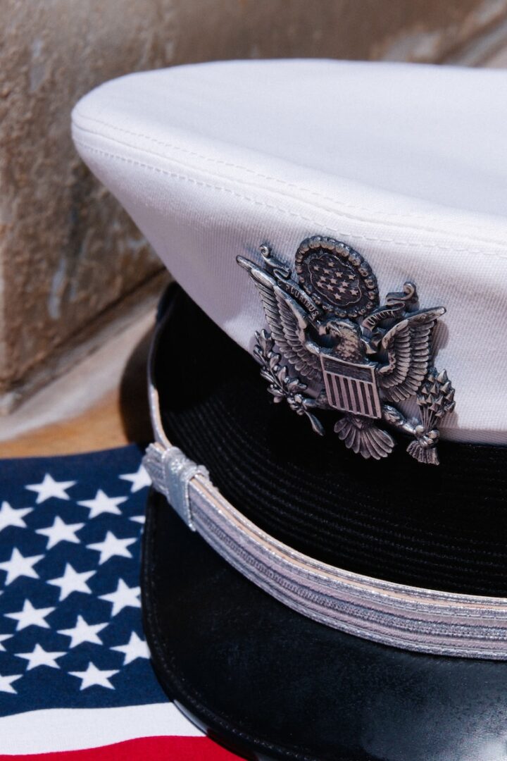a close up of a hat on top of an american flag