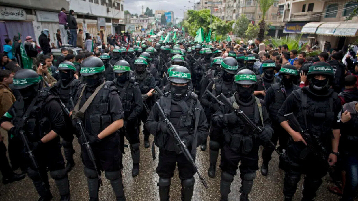 A large group of security personals holding guns and wearing helmets